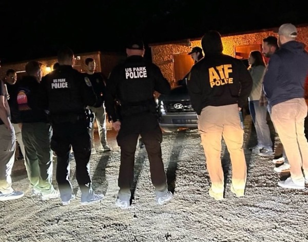 A group of ATF officers surrounding a car at night