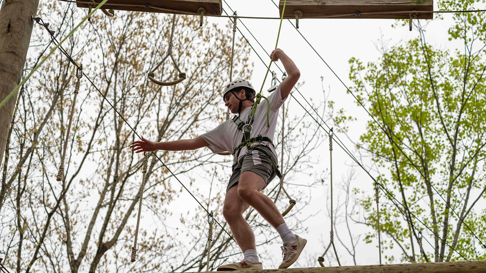 a student balancing on a ropes course
