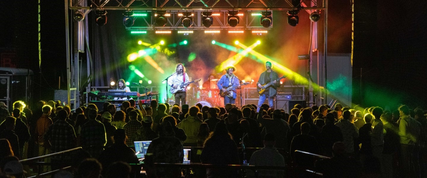 Hampden-Sydney College students surrounded by light beams at a concert