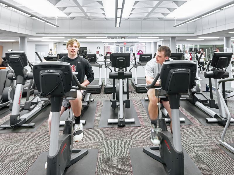 two students doing cardio in the fitness center