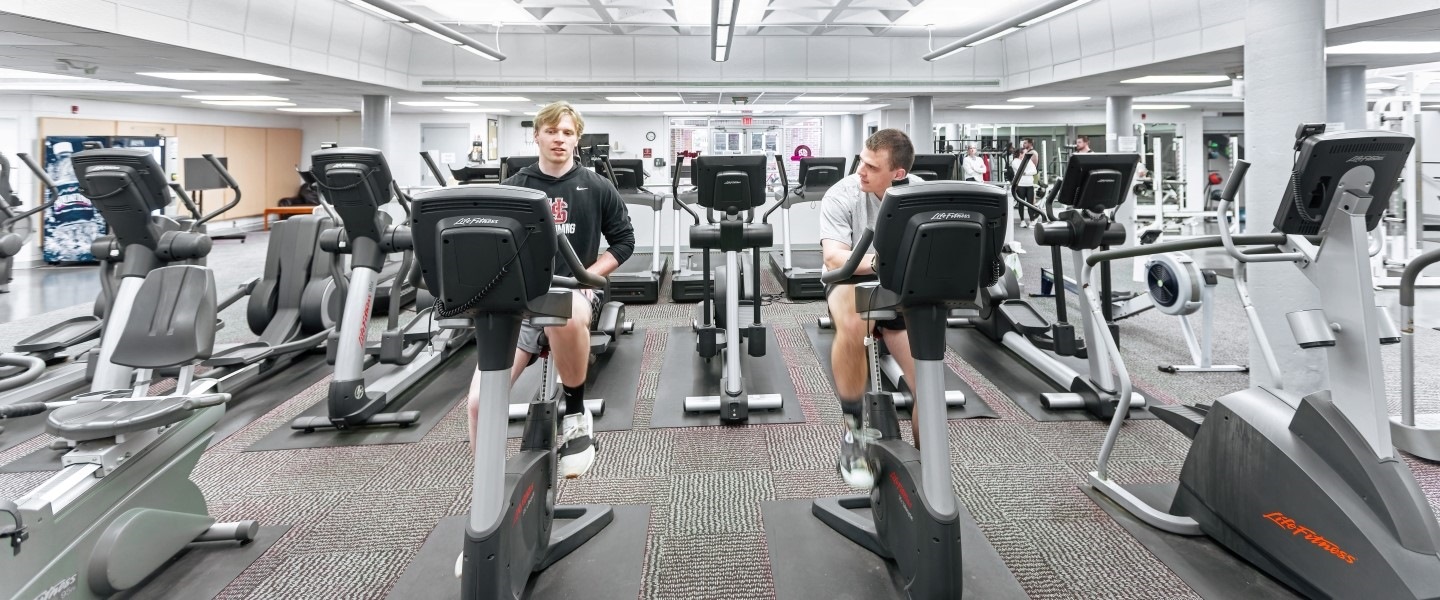 students working out and doing cardio in the gym