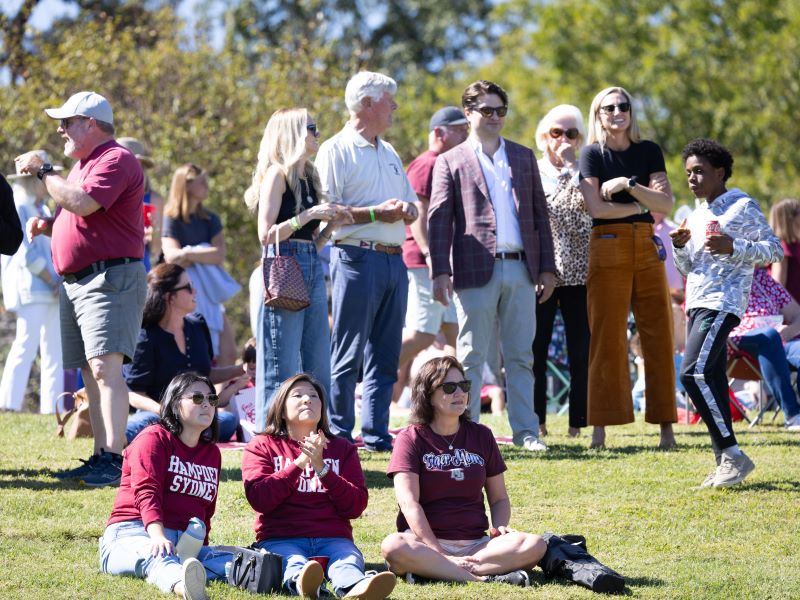 a group of fans watching the football game from the Hill