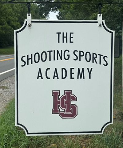 a sign that reads, "The Shooting Sports Academy"