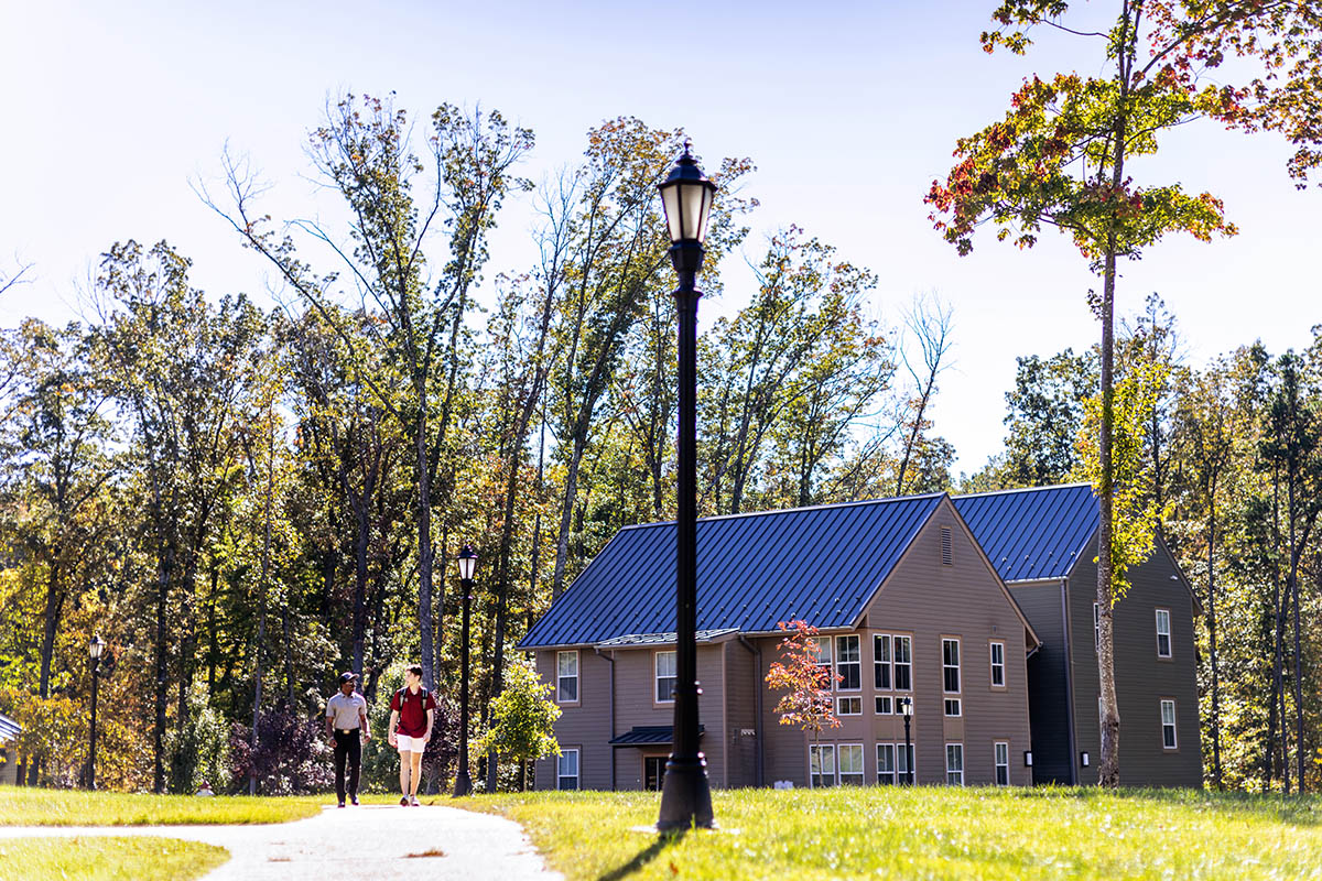 students walking through a residential dorm area