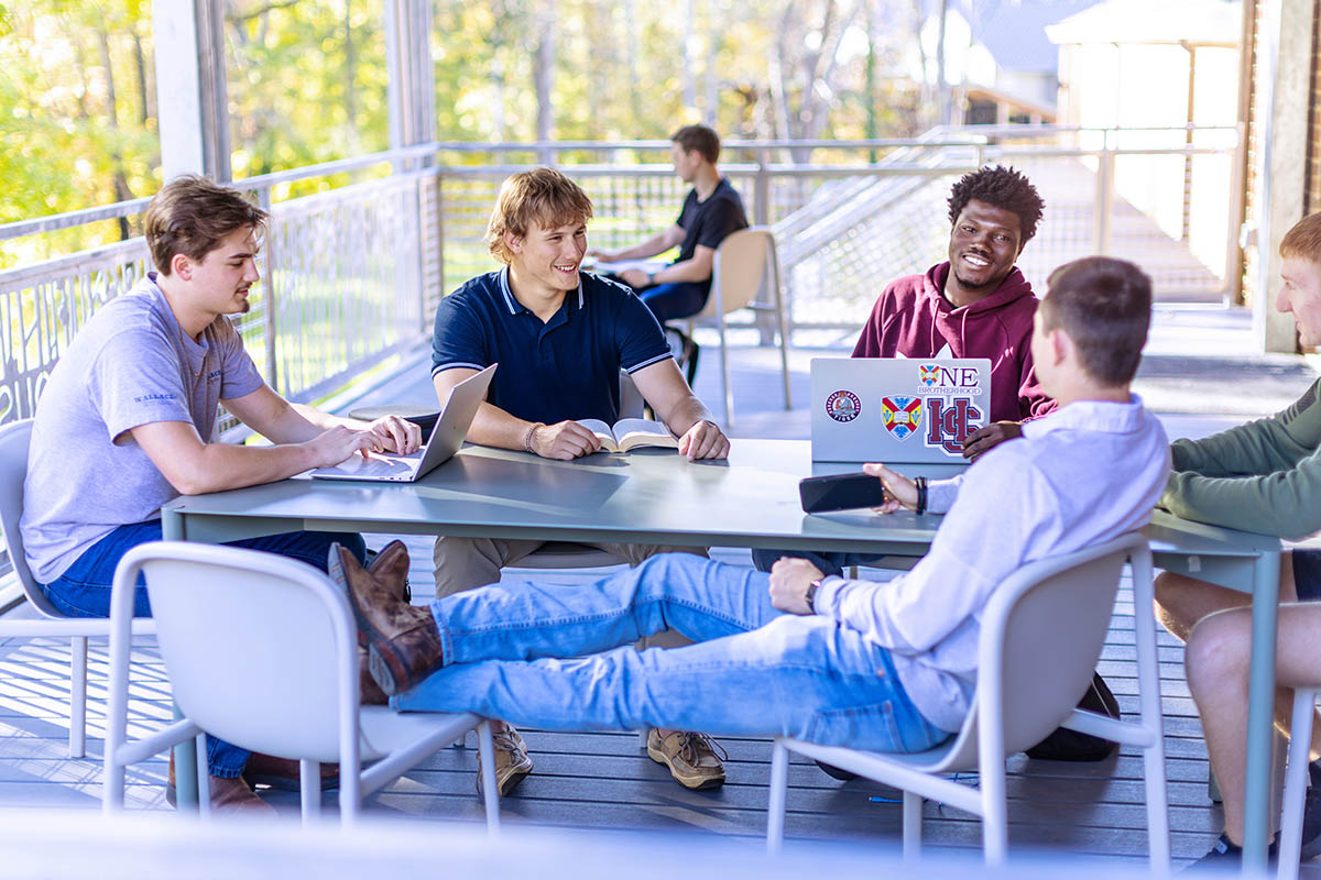 students hanging out on their outdoor porch deck