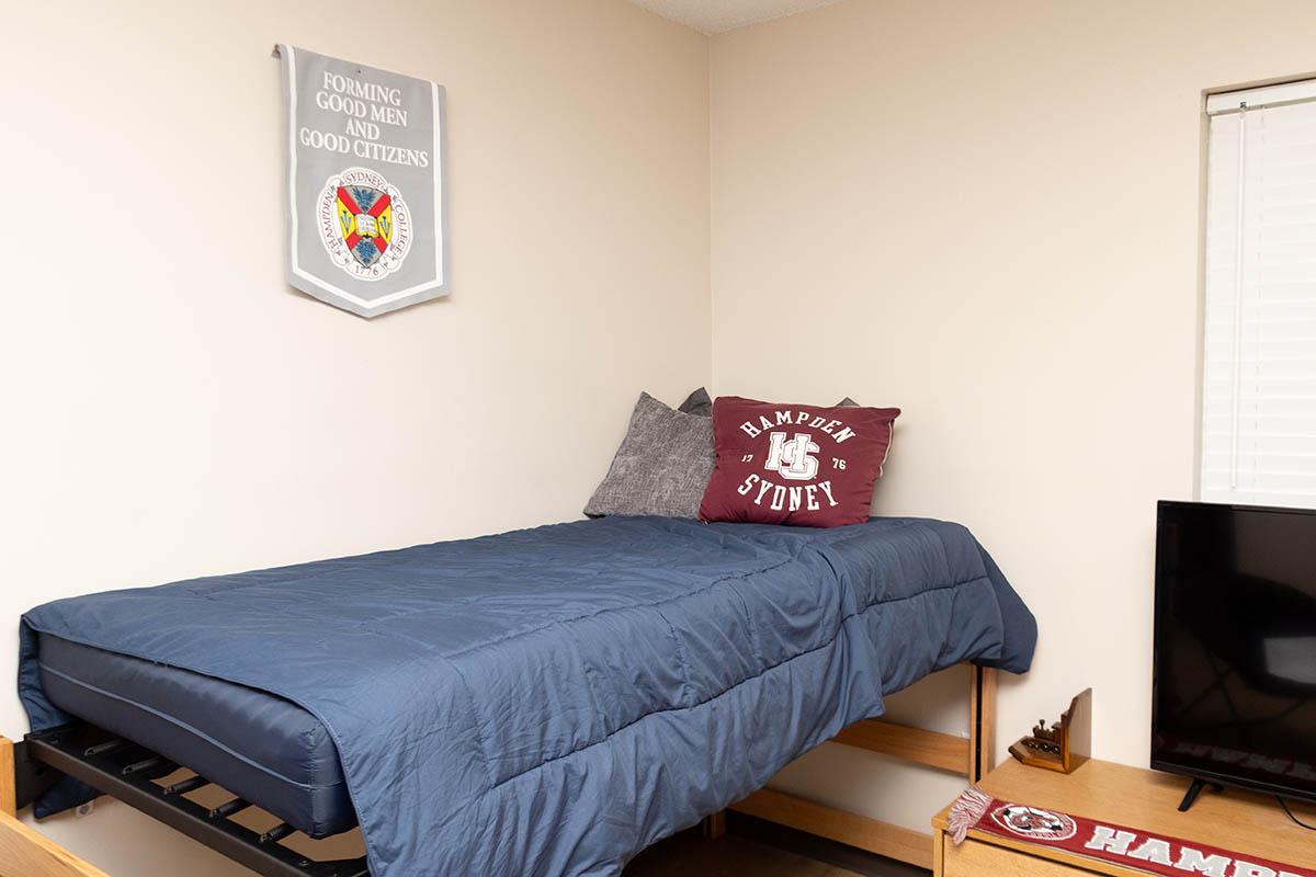 a bed and desks inside a Carpenter residence hall dorm room