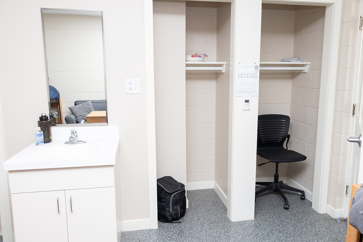 a sink and two closets inside a dorm room in Whitehouse Hall