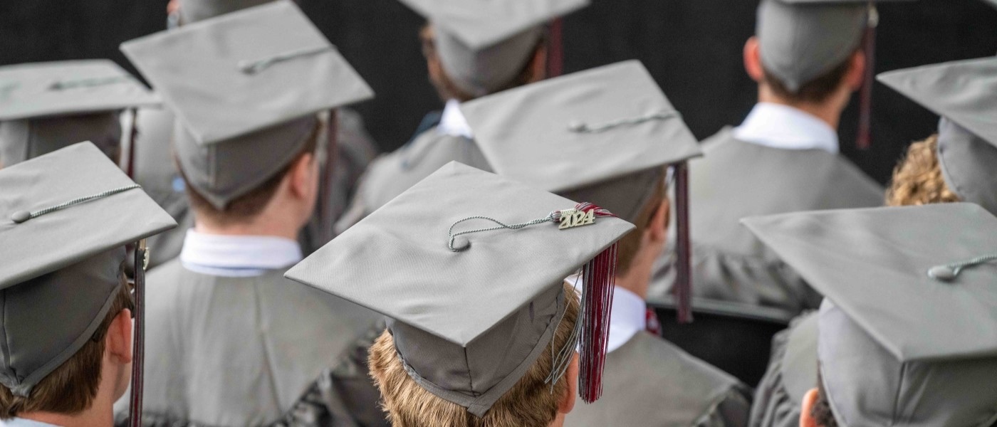 View of Hampden-Sydney College graduates' heads with mortarboards at commencement on Venable lawn