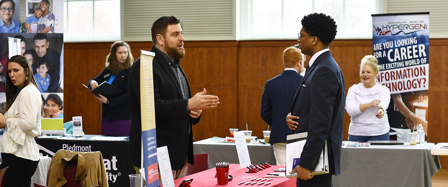 a student speaking about internship possibilities at a career fair