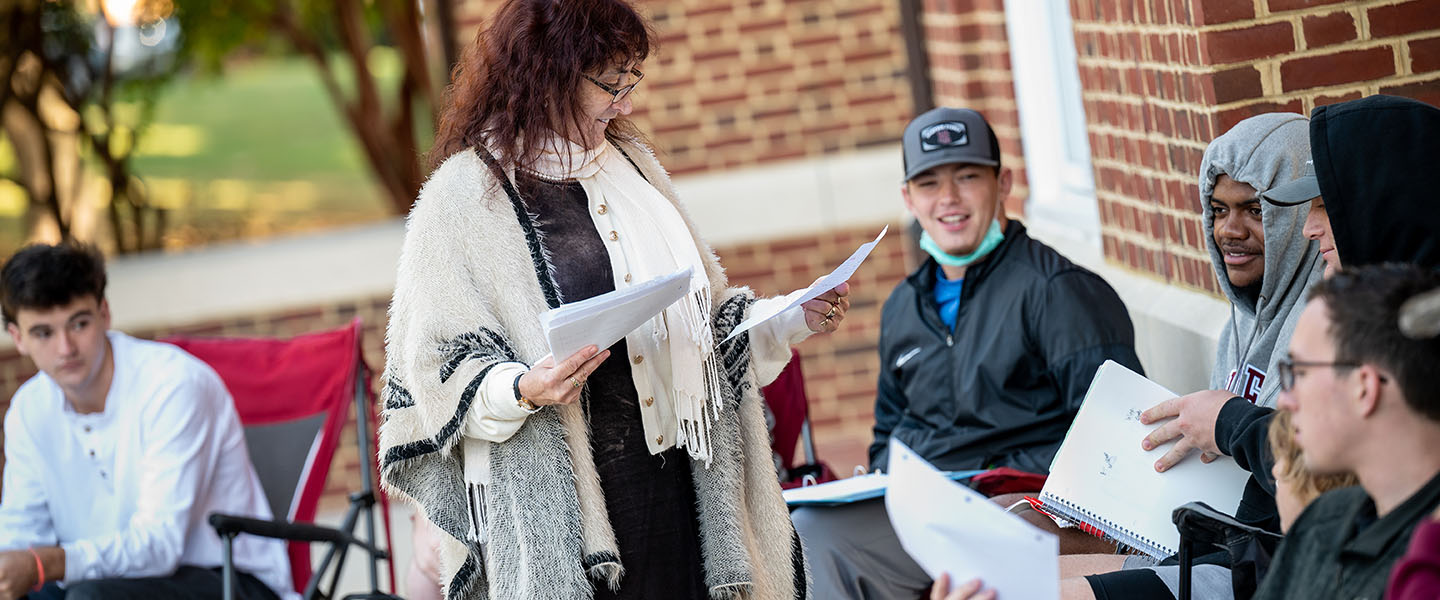 Hampden-Sydney students having class outdoors with Professor Thornton