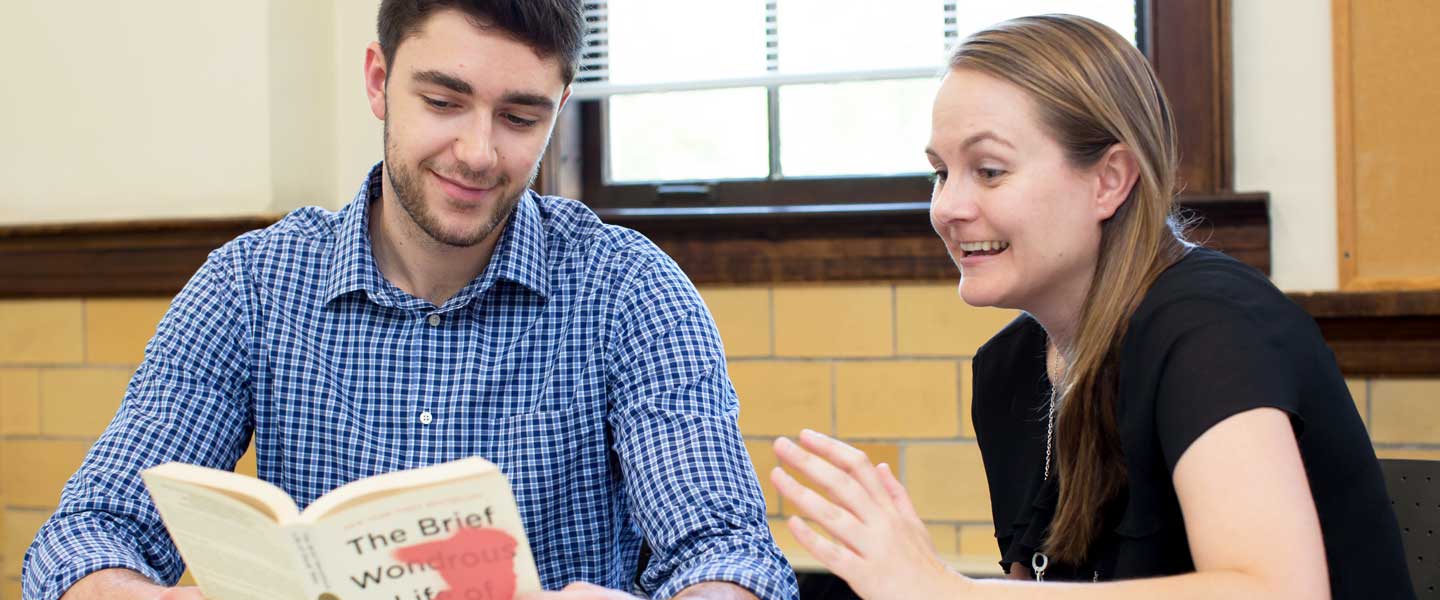 English Professor Horne reading with a student
