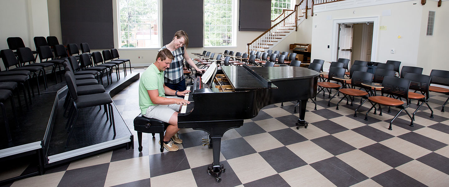 Professor von Rueden with practicing piano student in Brinkley Hall