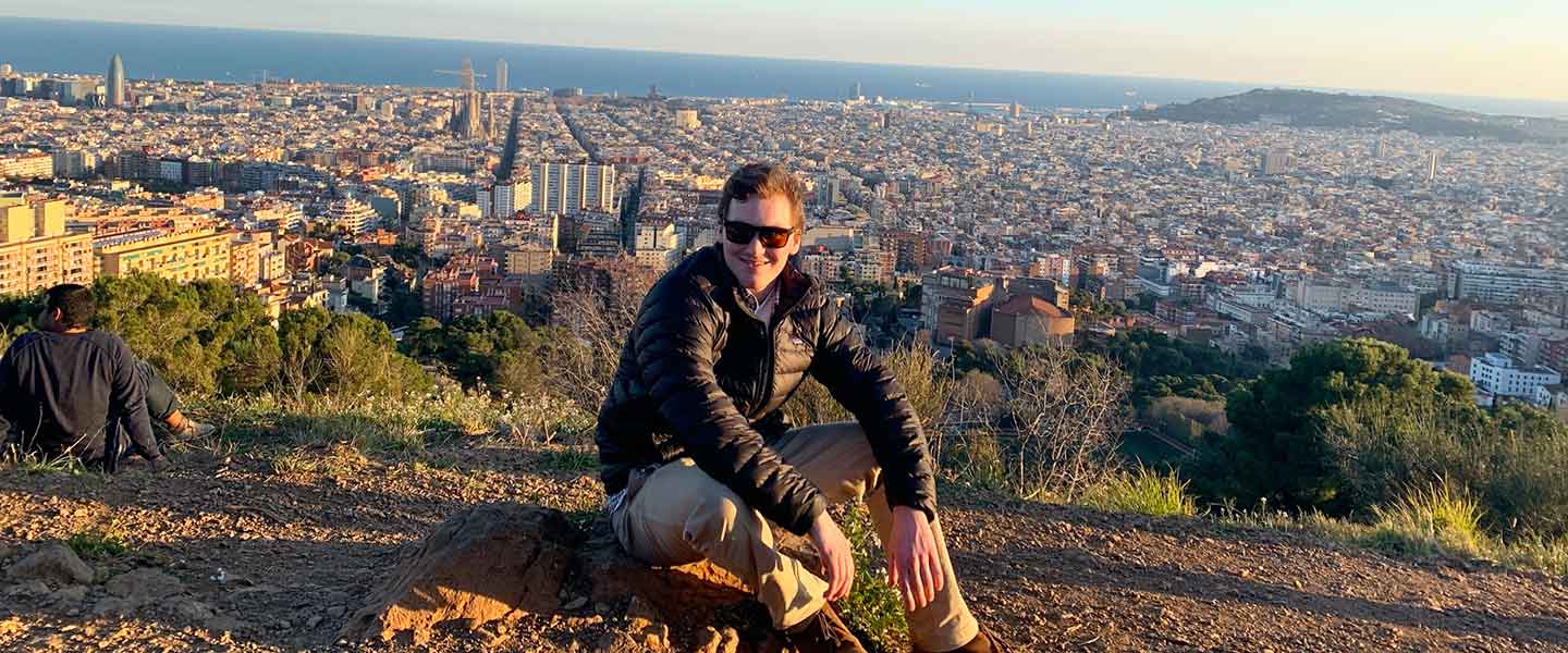 Student Anthony Vinson in front of a cityscape of Spain