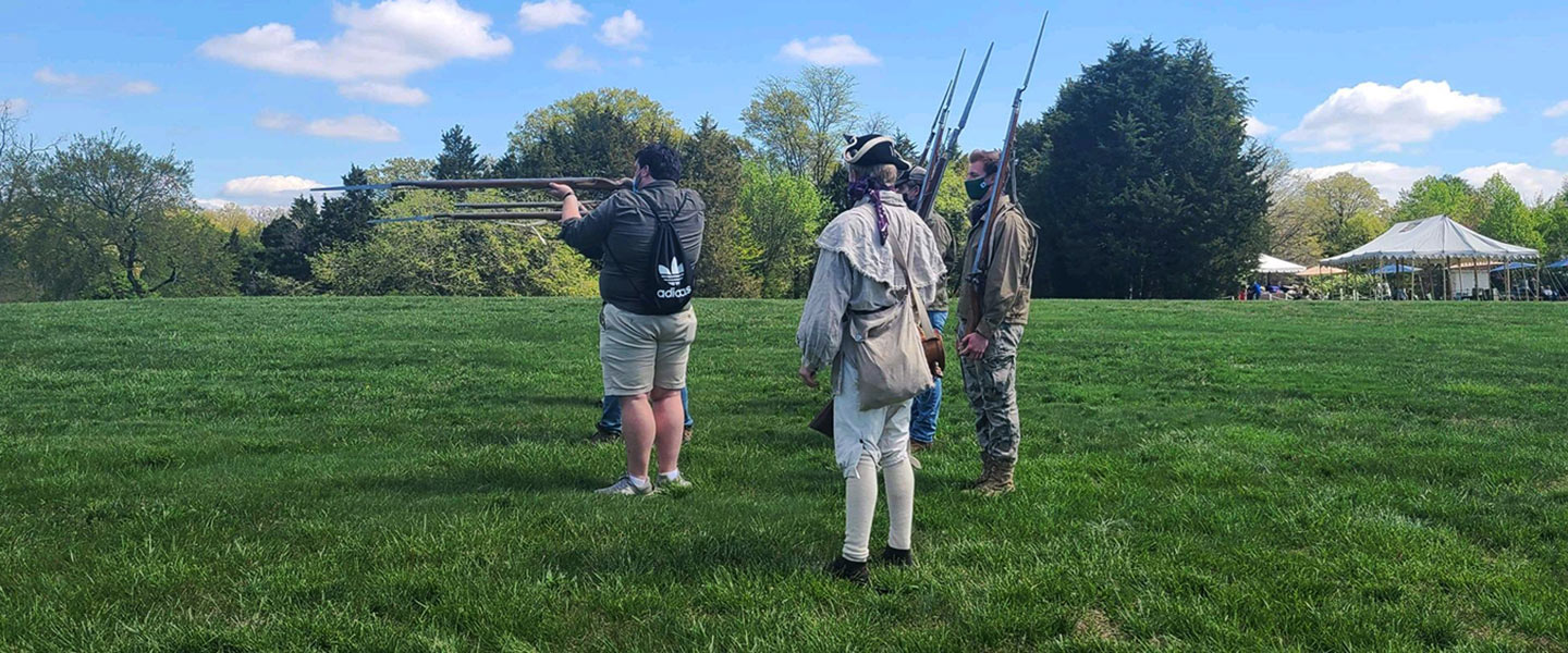 Students firing historic Revolutionary era muskets