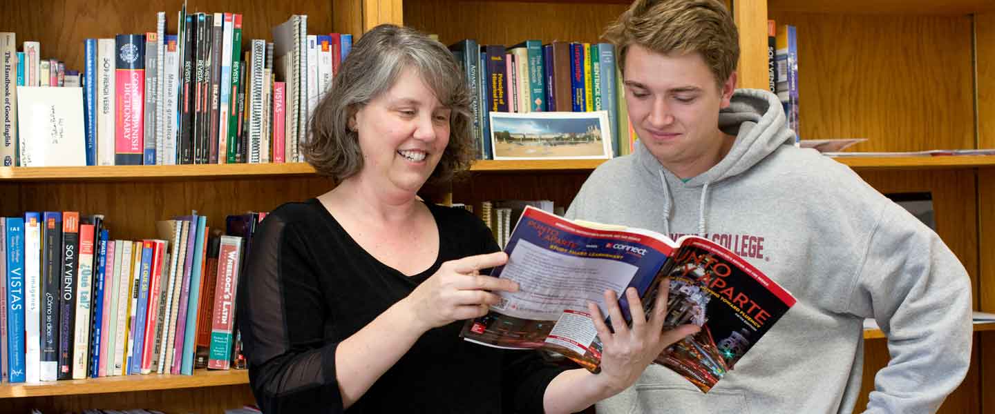 Professor Palmer looking at a book with a Hampden-Sydney College student