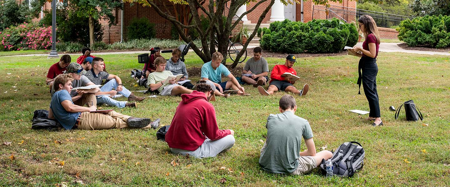Professor Elser holding class outdoors in front of College Church