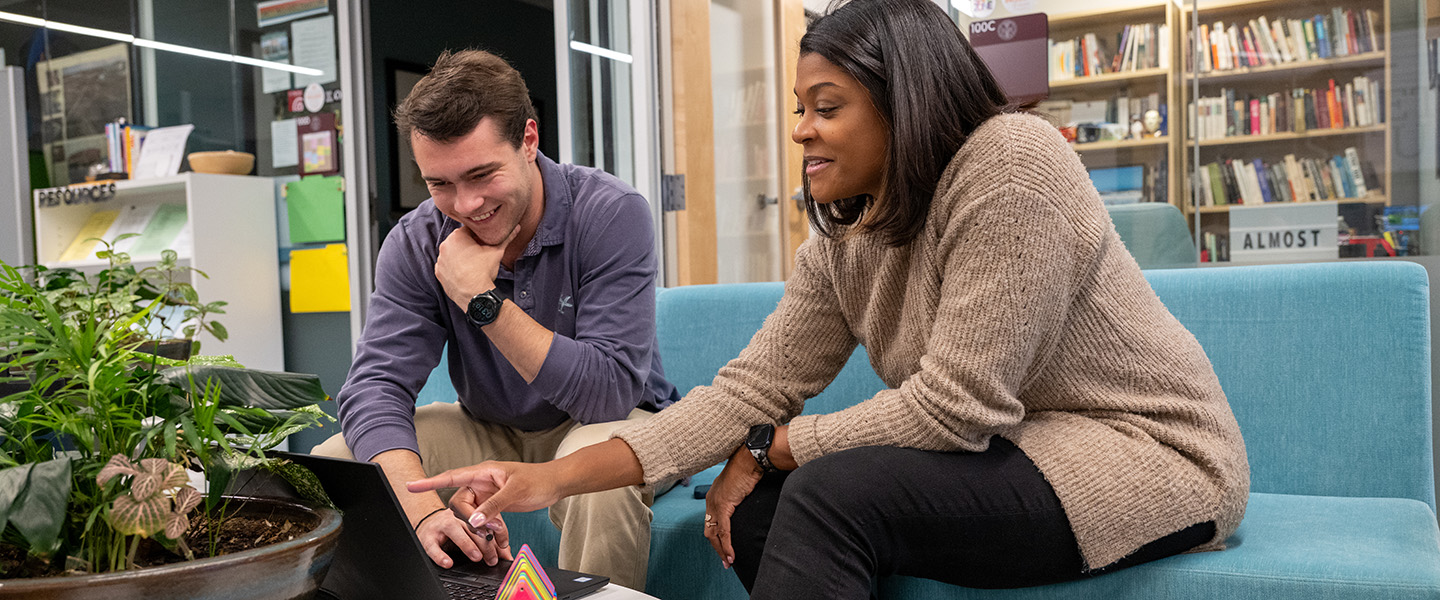 Student and professor working together on a computer in the RhetoricStudio