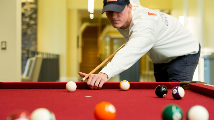 Student playing pool in Brown Student Center