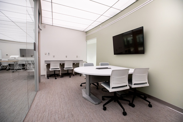 A workspace has a camera to record presentations and an interactive board to work on projects collaboratively.