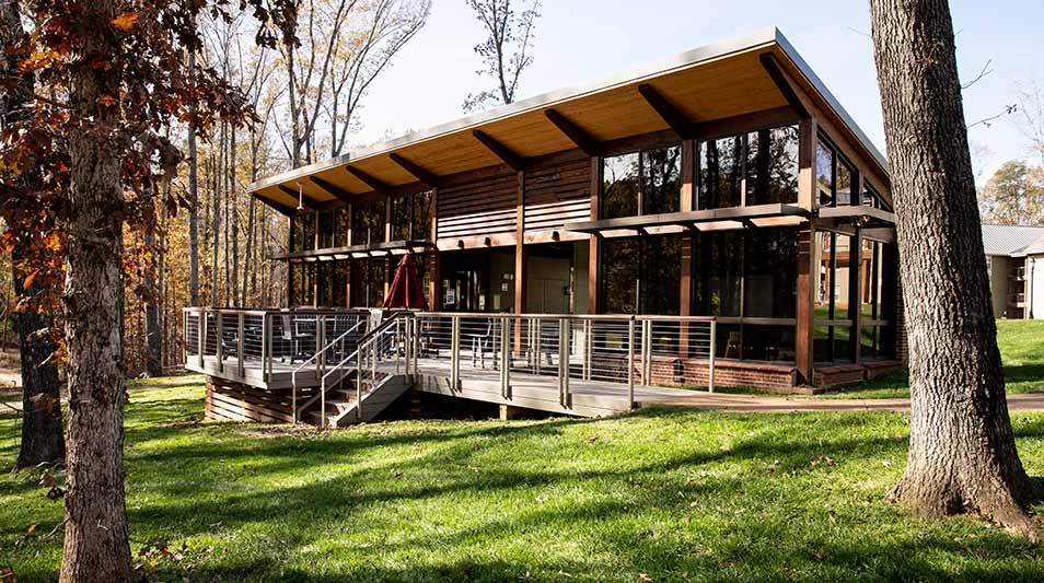 the community building in the trees at the new residence hall buildings at Hampden-Sydney College