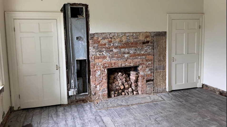 Uncovered fireplace in student room