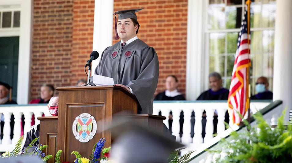 Commencement 2021 graduates Tyler Howerton at the podium delivers an address to the crowd