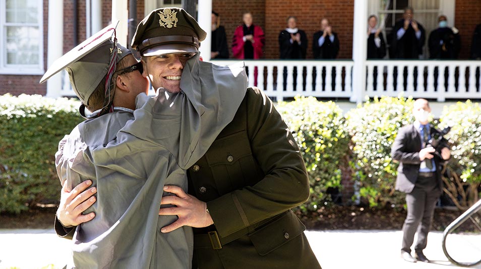 Commencement 2021 graduate and commissioned officer embrace