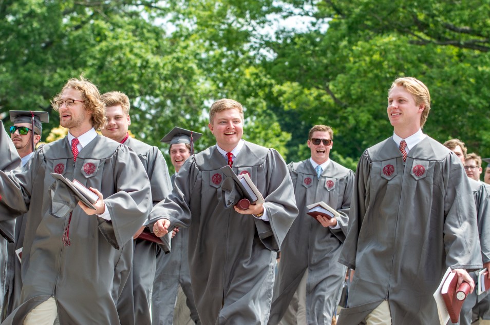 excited graduates leaving commencement