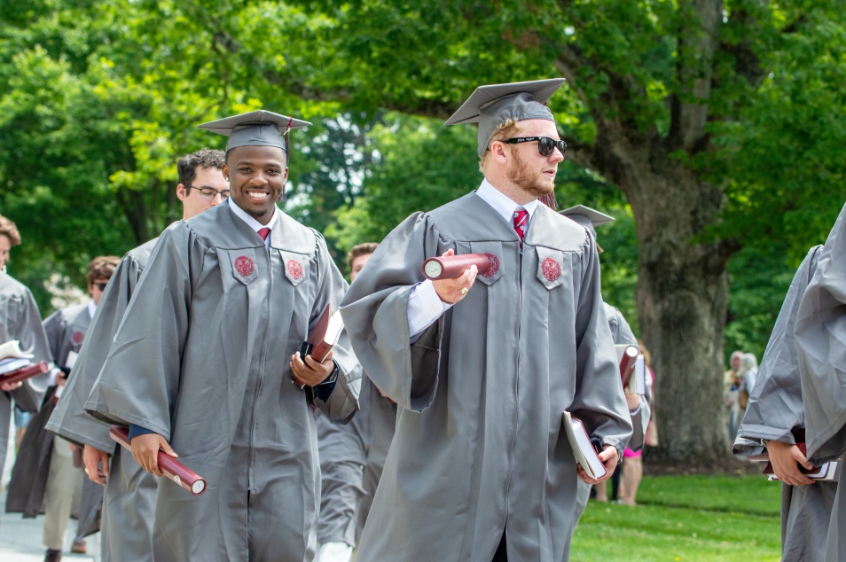 students smiling as they leave graduation