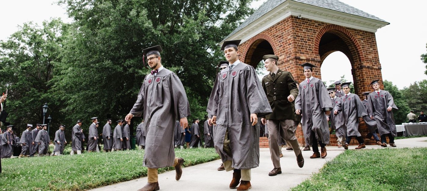 2023 graduates in regalia processing through the Bell Tower at Hampden-Sydney College commencement