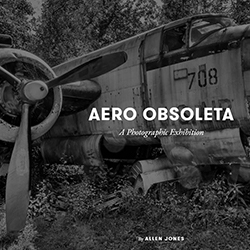 "Aero Obsoleta" written on a black and white cropped image of a crashed war plane
