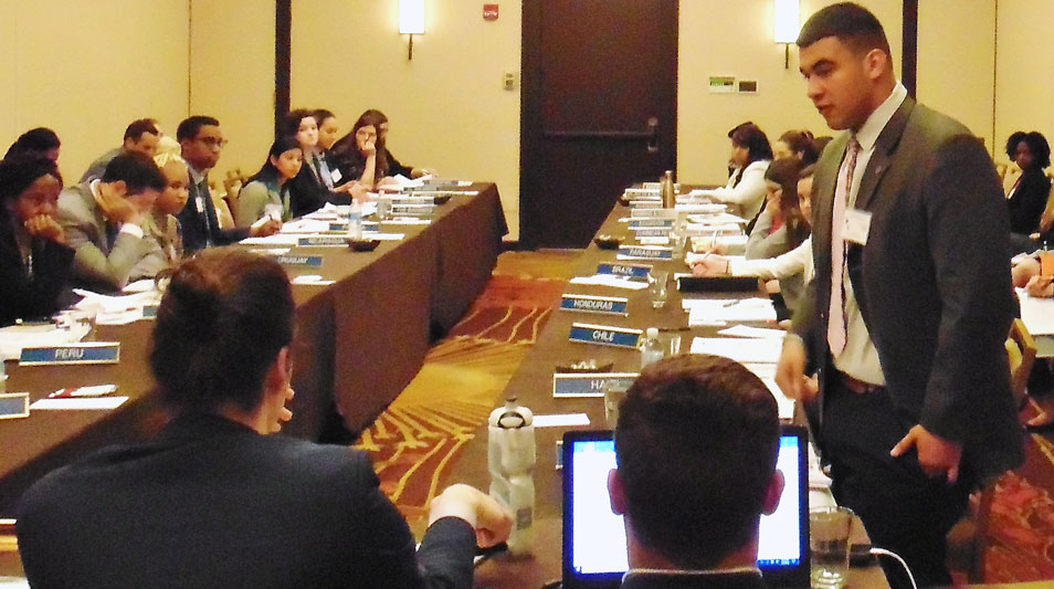 students debating in a conference room