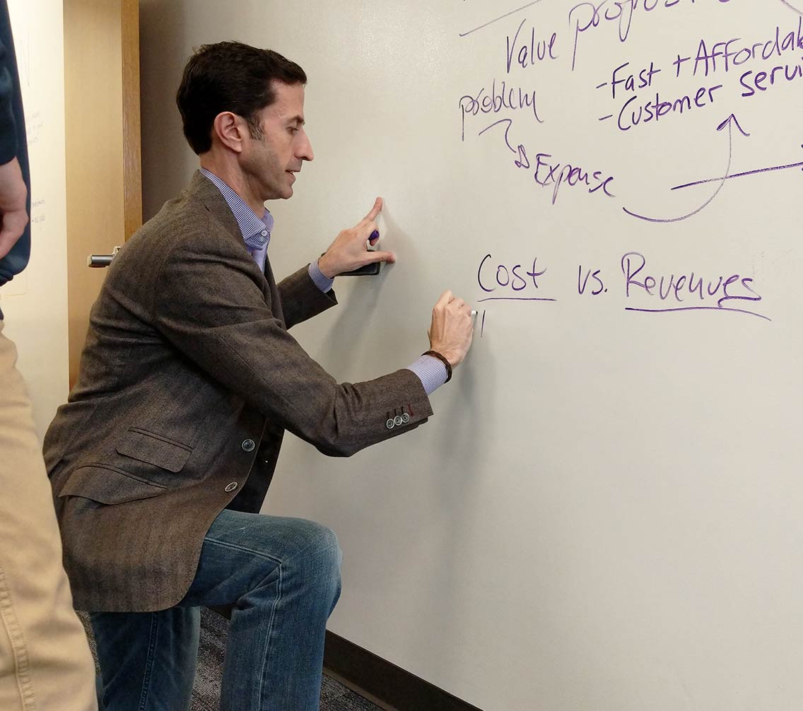 Dr. King writing on a whiteboard