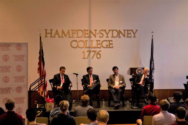 Panel discussion with men gathered on a stage