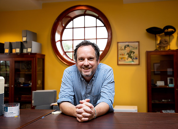Colin Woodward archivist sitting at his desk