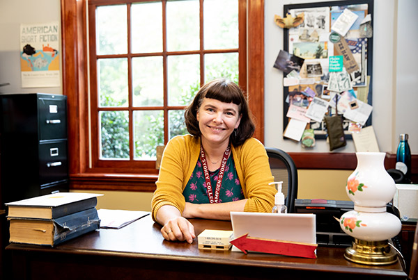 Sarah Almond, archivist sitting at her desk