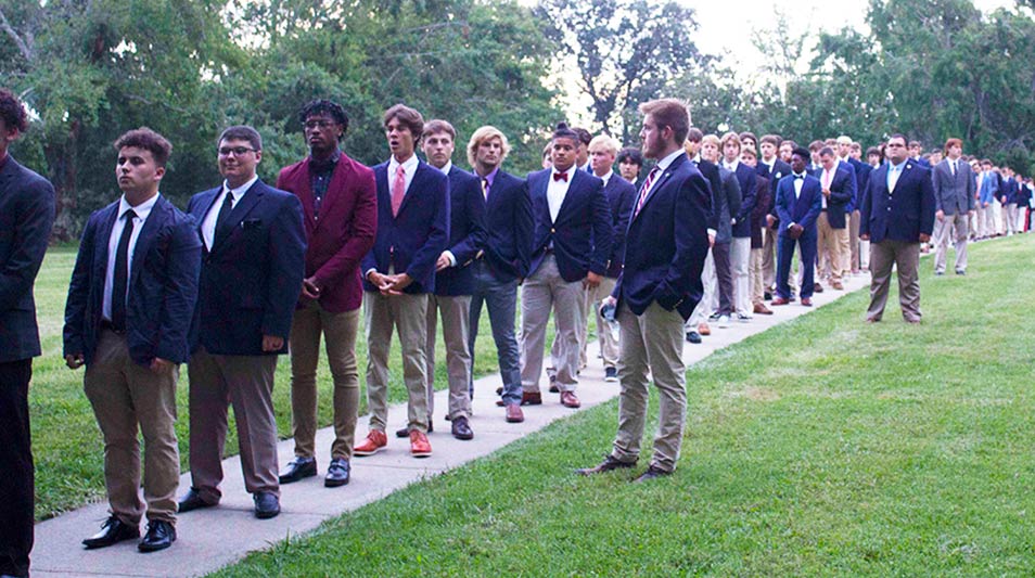 New students in coat and tie wait in line to sign the Honor Pledge