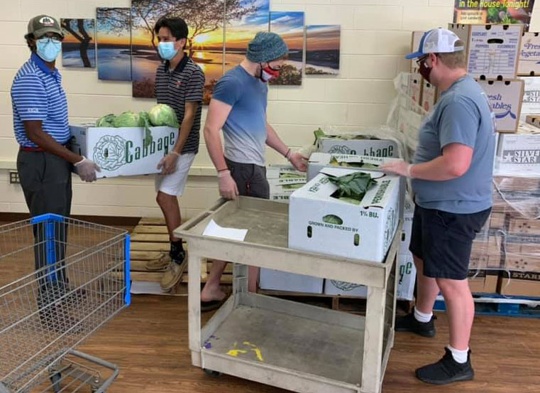 Hampden-Sydney student volunteers sorting boxes of food