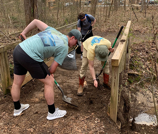 H-SC students doing trailwork around a bridge