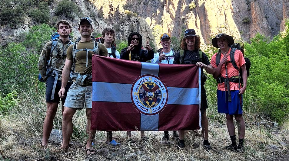 Hampden-Sydney students pose with an H-SC flagin the Gila Wilderness