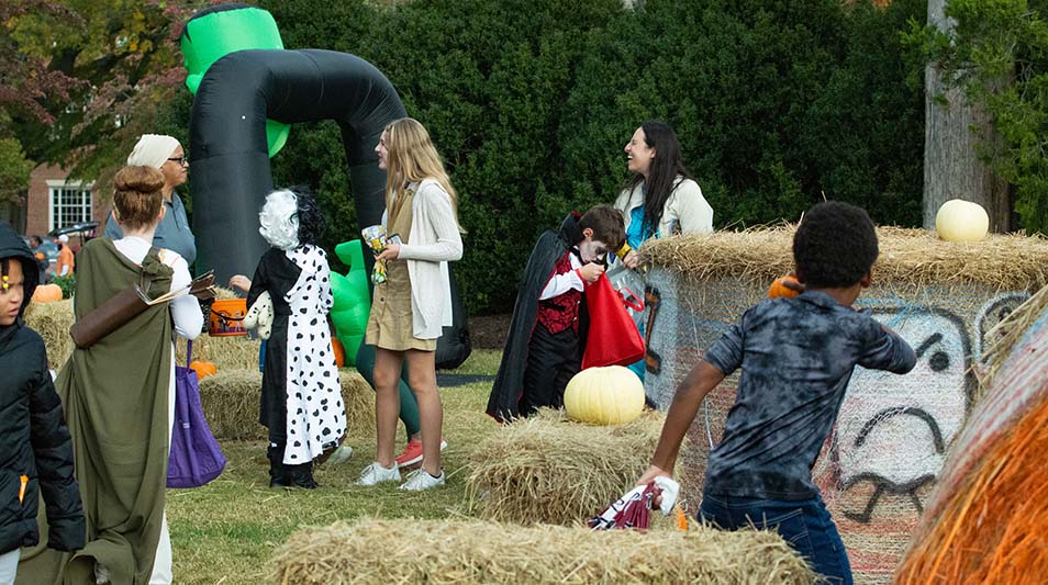 children playing in a haybale maze on Halloween 