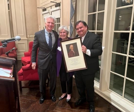 Louise Martin and President Stimpert standing with his award