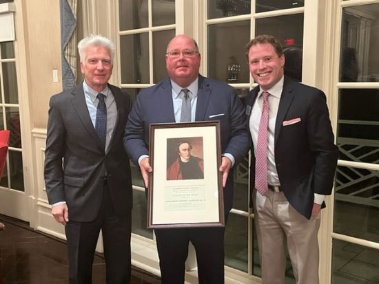 Ed McMullen and President Stimpert standing with his award