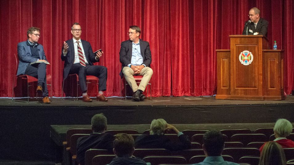 a panel of alumni sitting on the Johns Auditorium stage