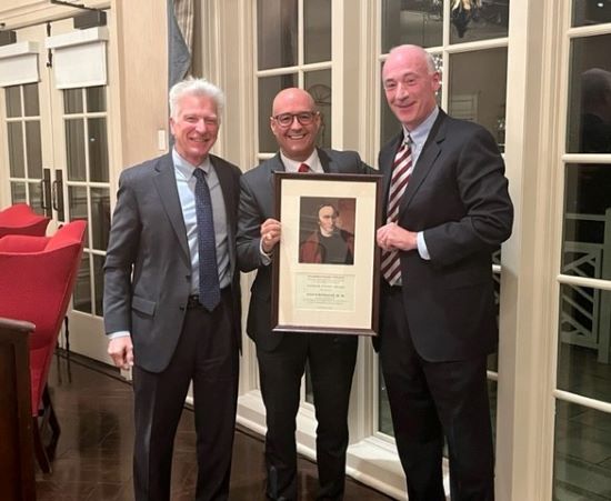 Hugo Rodriguez and President Stimpert standing with his award
