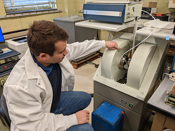 a student in a labcoat working in a biochemistry lab