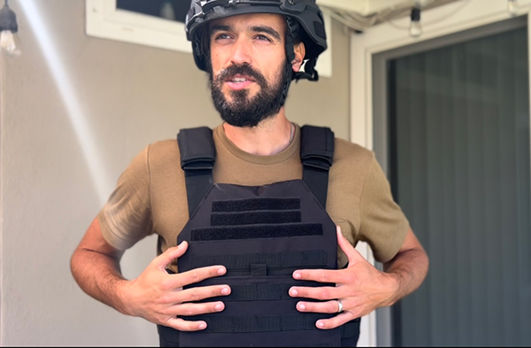 Yevhen (Zhenya) Goncharov wearing a bulletproof vest and helmet