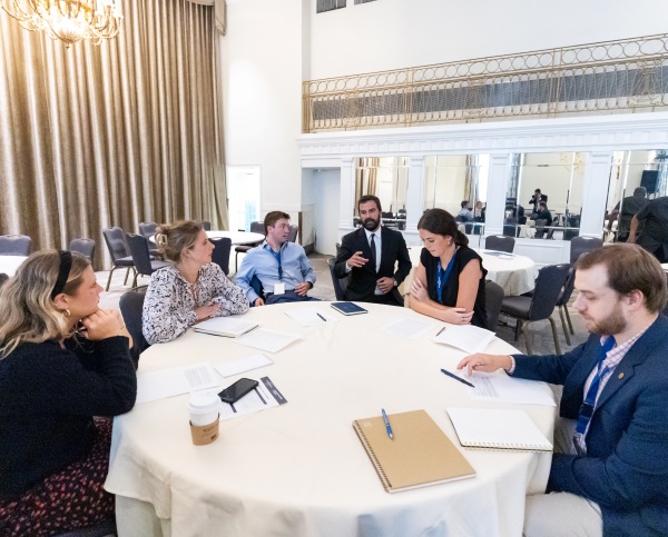 William Gardner ’25 and Devan Modak ’26 sitting at a conference table