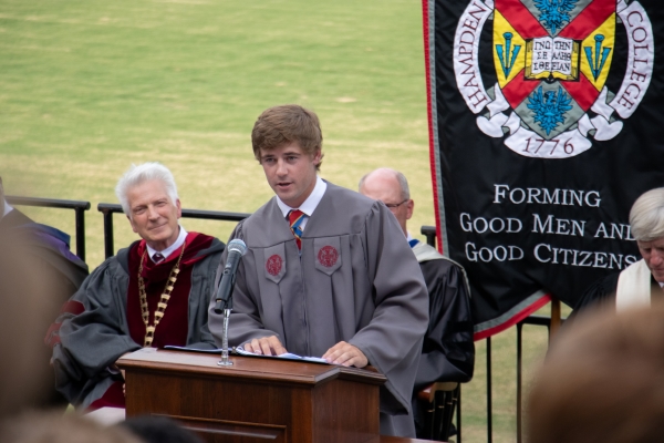 a student in ragalia giving a speech infront of the student body
