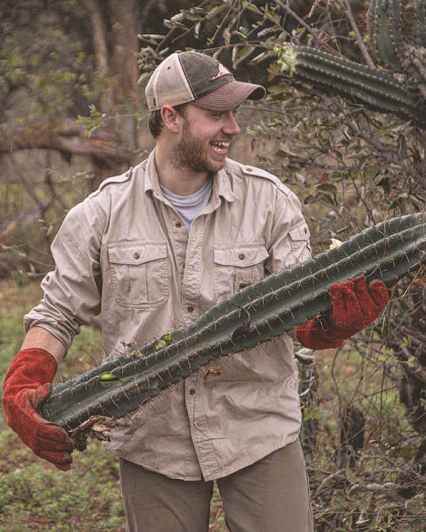 William Gardner '25 holding a large cactus